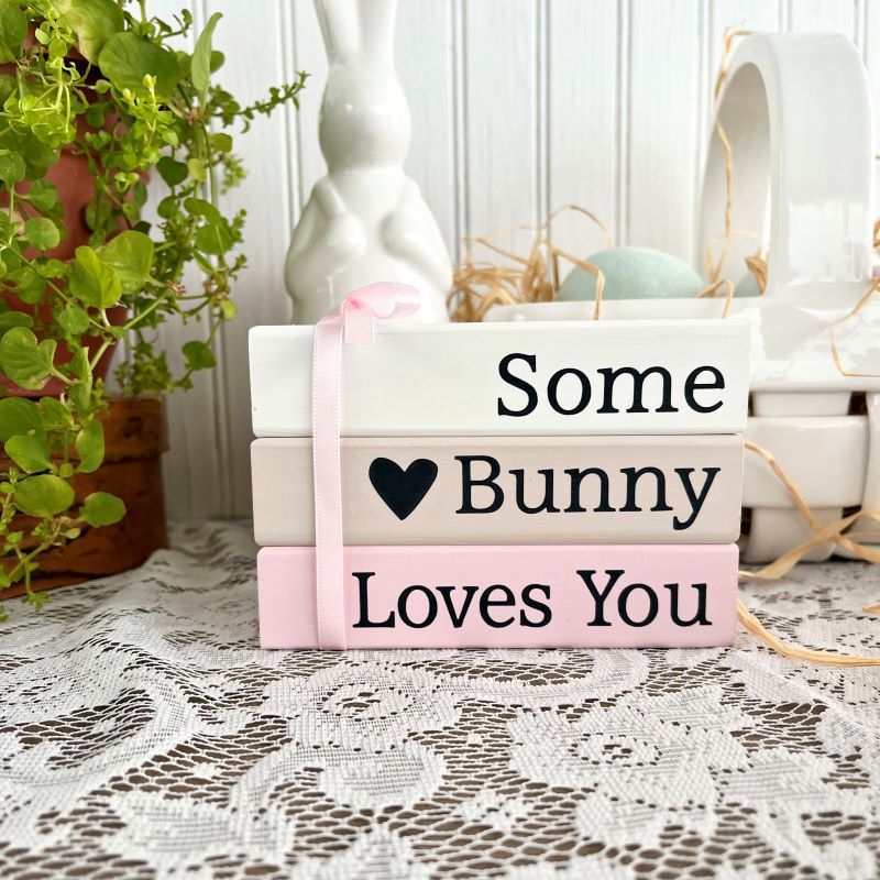 Set of 3 stacking blocks  white, tan and pink with black lettering that says some bunny loves you.  Faux book stack. #tiered tray decor #spring decor #easter decor