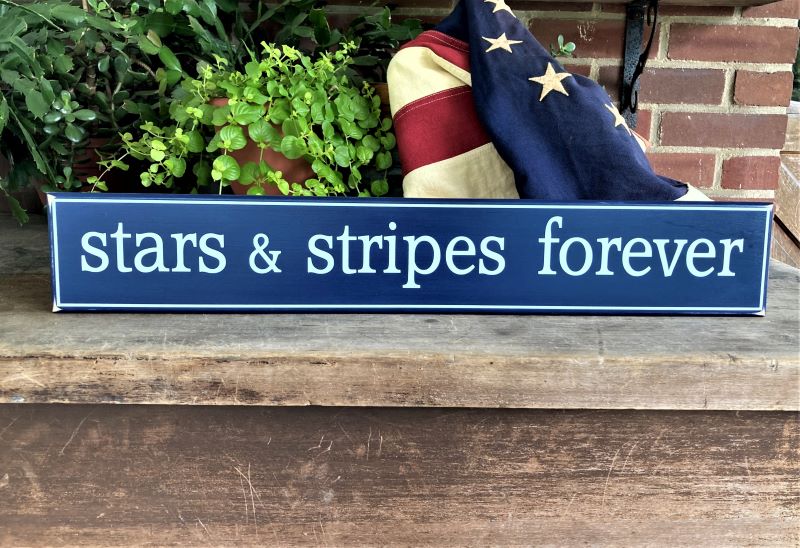 4x24 inch wood sign painted dark blue with white lettering saying stars and stripes forever.  Patriotic decor.