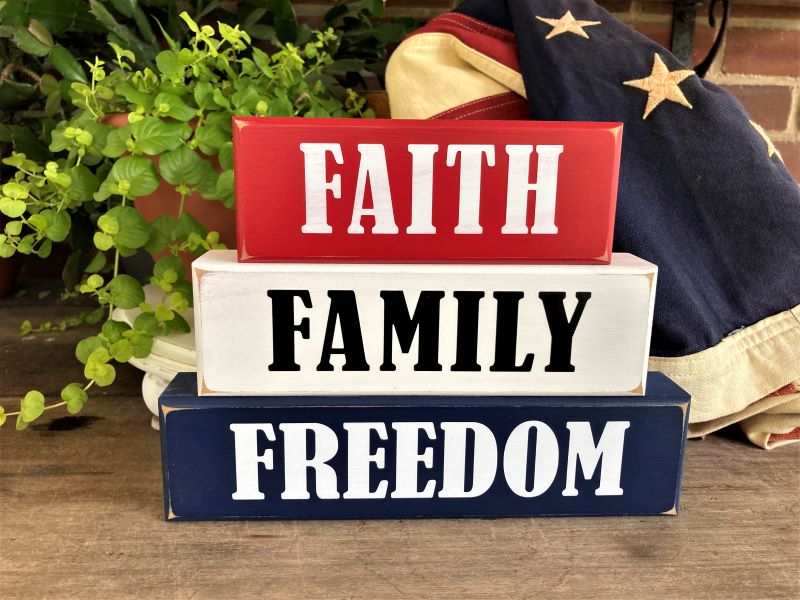 Faith Family Freedom Set of 3 wood blocks.  6 3/4 h x 9 w x 1 1/4 deep inches.  Painted Red, White and Blue with white and black lettering. 