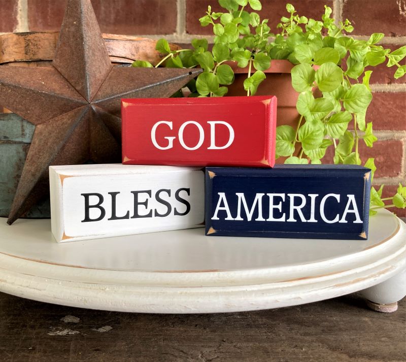 Set of 3 mini stacking blocks.  Red White and Blue with words God Bless America. Each block measures 1.75x4inches