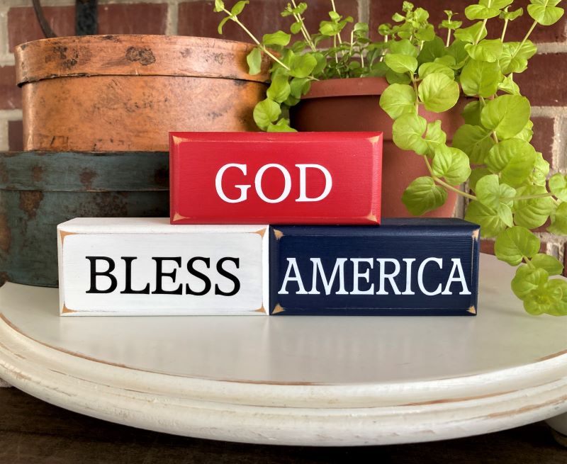 Set of 3 mini stacking blocks. Red White and Blue with words God Bless America. Each block measures 1.75x4inches
