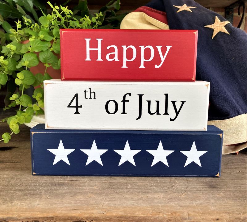Happy 4th of July Set of 3 wood blocks.  6 3/4 h x 9 w x 1 1/4 deep inches.  Painted Red, White and Blue with white and black lettering. Perfect decorFor Independece Day decorating.