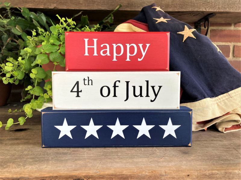 Happy 4th of July Set of 3 wood blocks. 6 3/4 h x 9 w x 1 1/4 deep inches. Painted Red, White and Blue with white and black lettering. Perfect decorFor Independece Day decorating.
