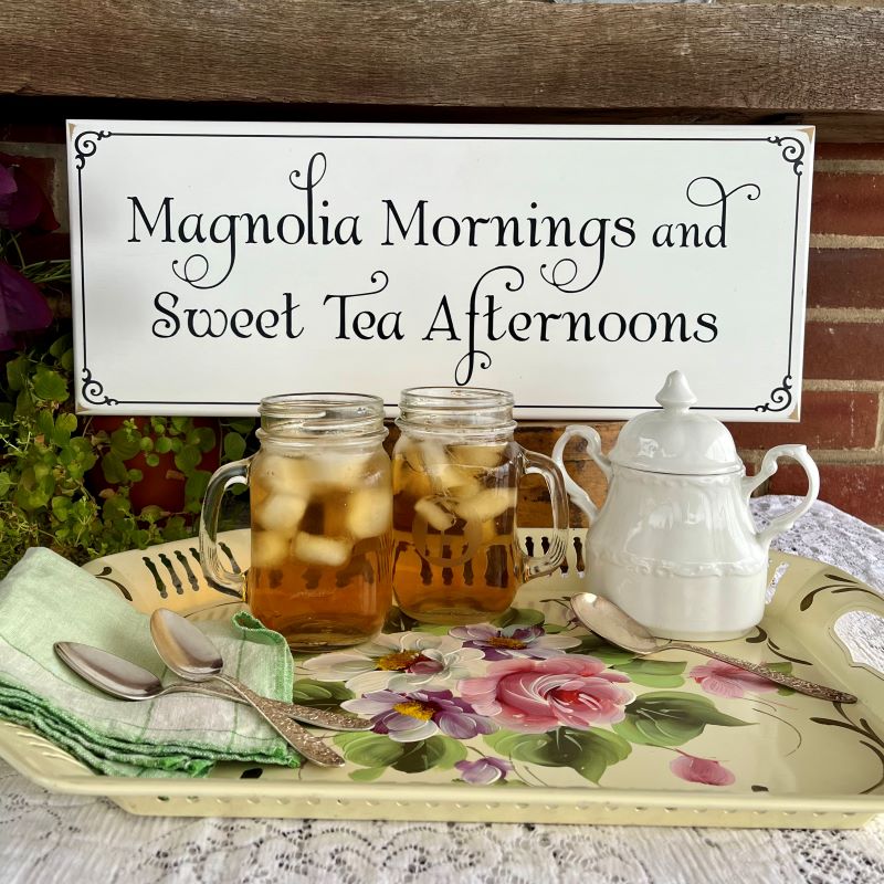 White wood sign with black wording saying Magnolia Mornings and Sweet Tea Afternoons. Available in 2 sizes  and several colors.  #southernliving 