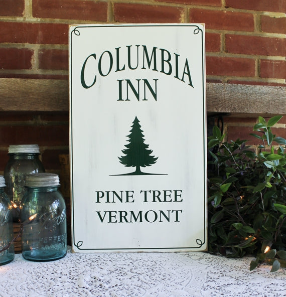 Columbia Inn Pine Tree, Vermont A tribute to White Christmas, this charming wood sign has a worn white finish with dark green lettering. A special addition to your Christmas decorating. Two sizes available. 12x20 or 16x27 inches.
