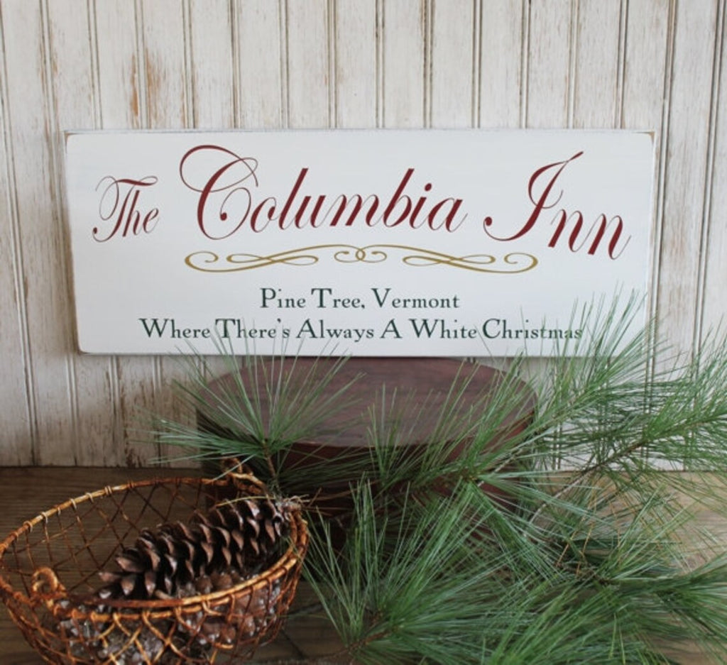 The Columbia Inn Wood Sign. Where there;s always a white Christmas . Worn finish white sign available in 2 sizes.