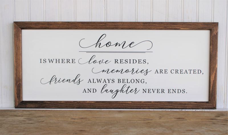 home is where love resides, memories are created, friends always belong and laughter never ends. on a white worn finish sugn in black lettering. Sign has a wood frame and measures9x21 inches. 
