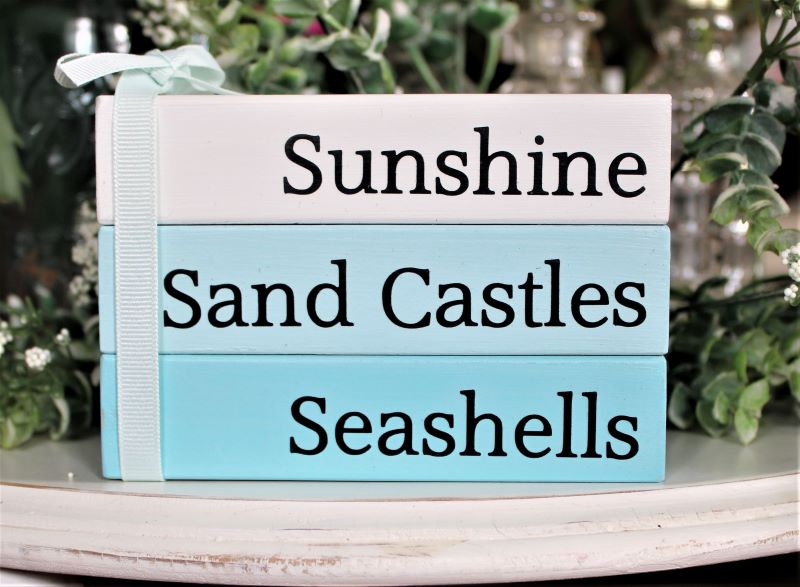 Sunshine Sand Castles Seashells Stack set of 3 wood blocks glued together and tied with a bow. White, aqua and pale aqua blocks with black lettering.  Faux book stack. 3 1/2 inches tall, 5 inches across and 2 1/2 inches deep. #beachdecor  Country Workshop.